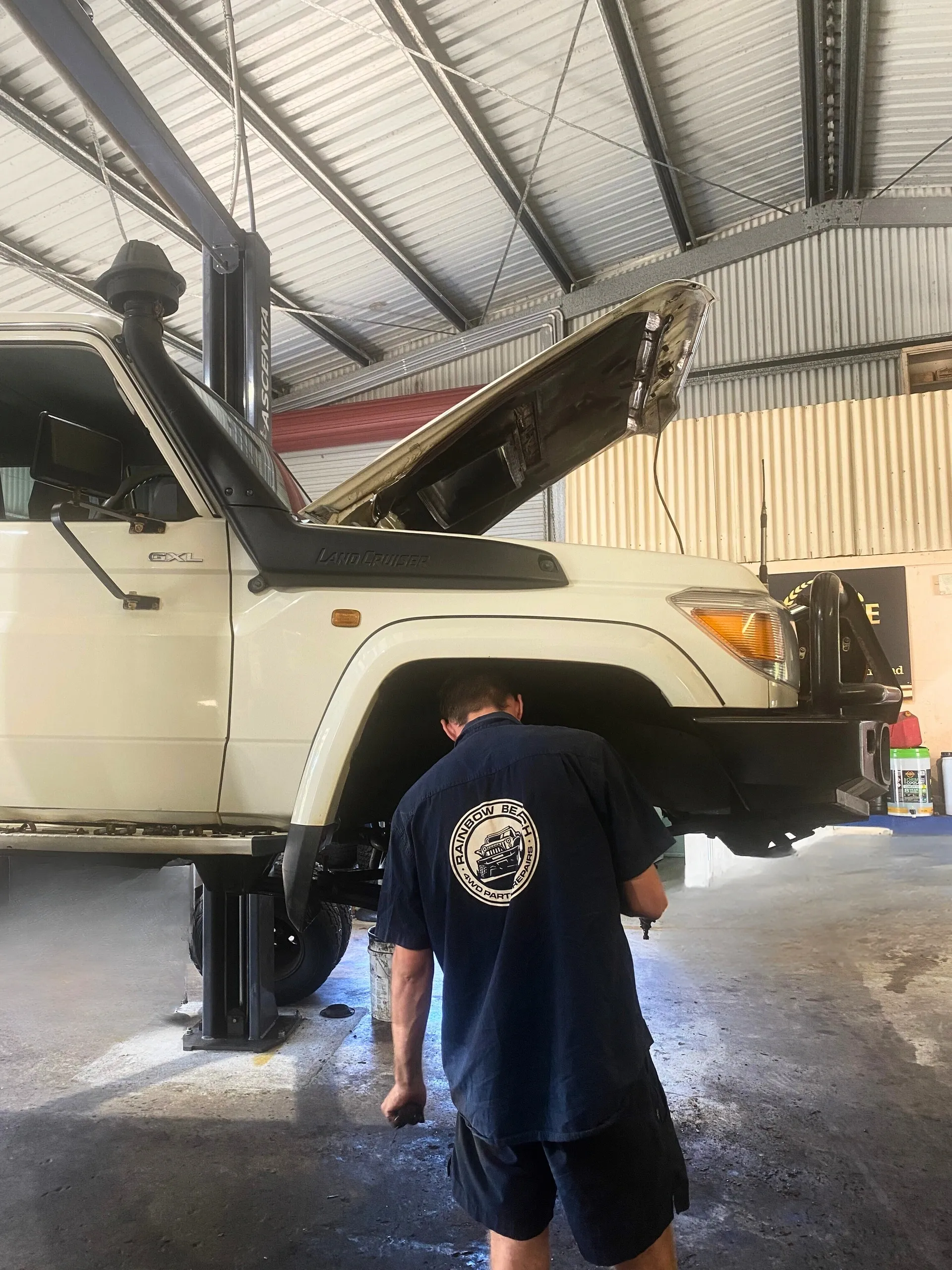 Rainbow Beach 4WD mechanic servicing a Toyota LandCruiser on the hoist in the workshop